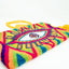 Pochette Soleico Clutch Wayuu avec Motif Oeil brodé Mauve Vert. Fait main motif Evil Eye. Artisanat Ethnique Responsable. Modèle similaire Enayim design Sac Colombien